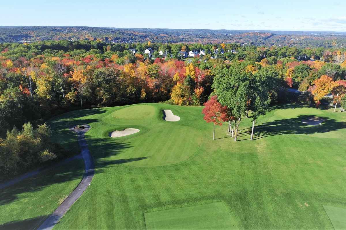 Aerial view of Highfields Golf & CC in Grafton, MA featuring lush fairways, tree-lined greens, and vibrant autumn foliage.
