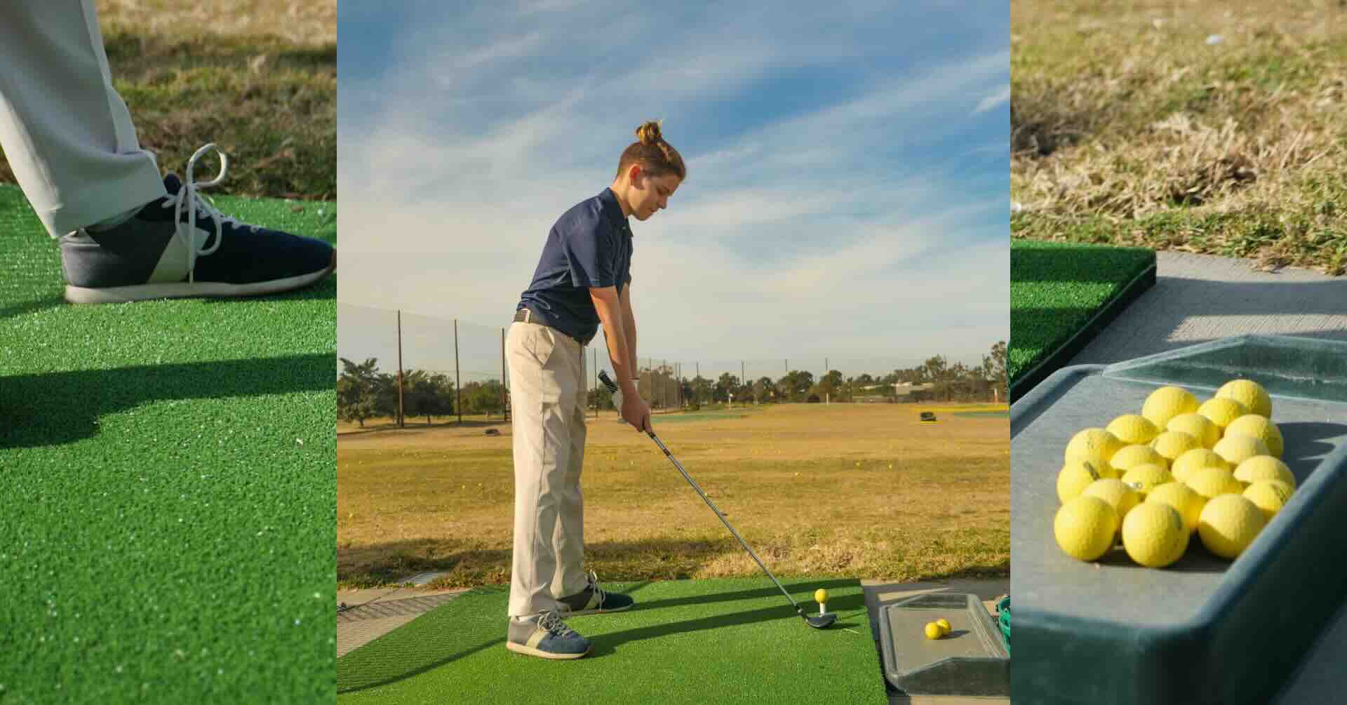 Young golfer at a driving range, lined up over a yellow ball on a green mat with practice balls and a clear sky in the background.