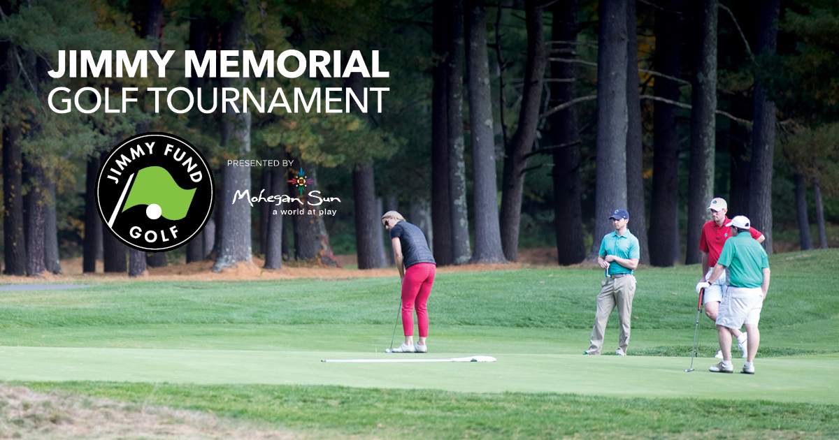 Four golfers stand and watch as one putts on a green at Juniper Hill Golf Course during the Jimmy Memorial Golf Tournament.